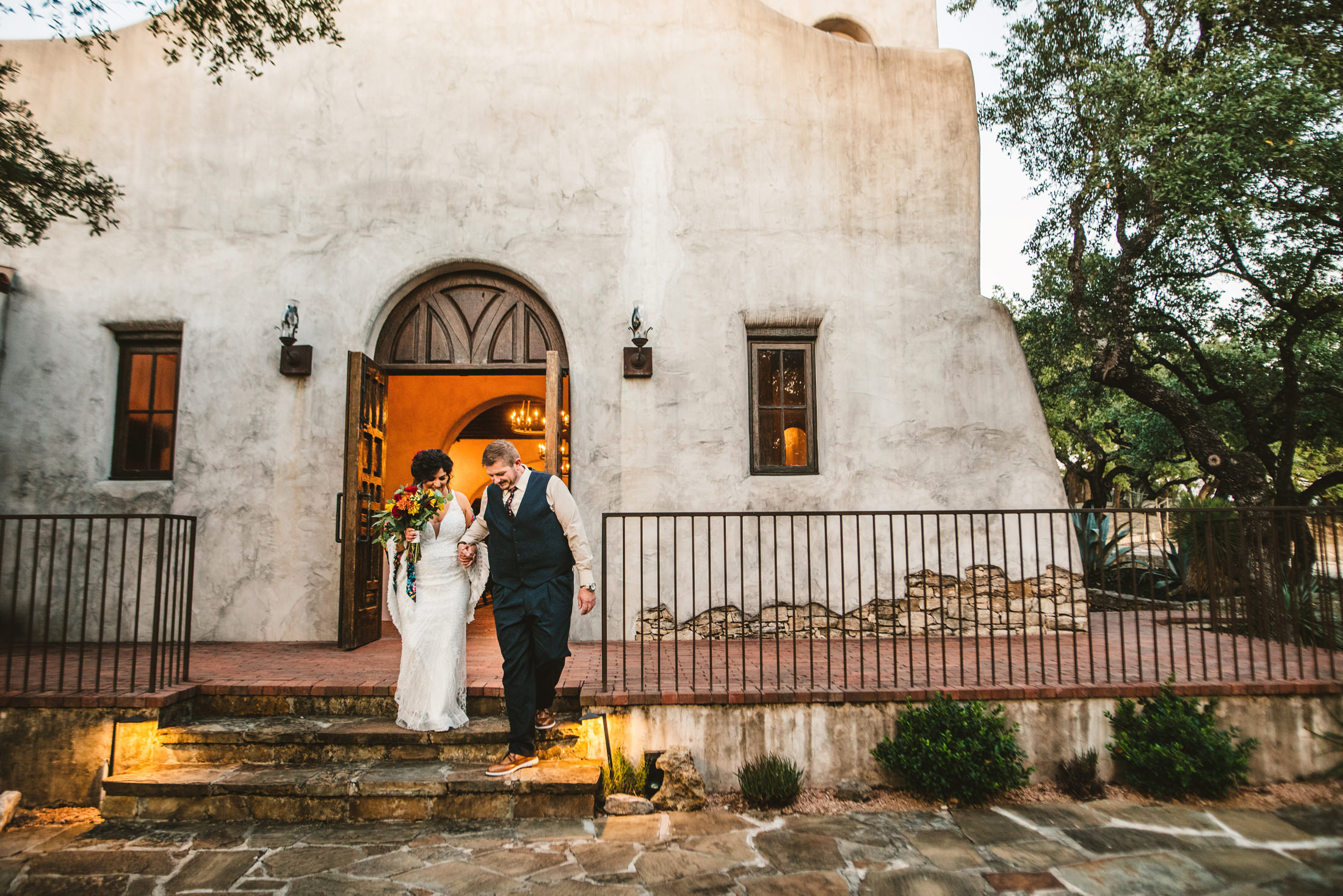 Bride and groom at a San Antonio mission-style venue, documentary wedding photo by photographer Christian Margain
